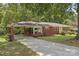 Well-maintained brick home with covered parking and a paved driveway at 207 W 21St St, Kannapolis, NC 28081