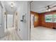 Hallway with a view into wood-paneled room with light-colored floors and a ceiling fan at 207 W 21St St, Kannapolis, NC 28081