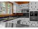 Close up of bright kitchen with updated stainless appliances and white cabinets with black countertops at 207 W 21St St, Kannapolis, NC 28081