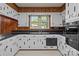 Bright kitchen featuring white cabinets, black countertops, and stainless steel appliances with a large window at 207 W 21St St, Kannapolis, NC 28081