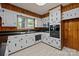 Bright kitchen featuring white cabinets, black countertops, and stainless steel appliances with a large window at 207 W 21St St, Kannapolis, NC 28081