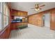 Open living area with wood-paneled walls, bright windows, updated floors, and a modern ceiling fan at 207 W 21St St, Kannapolis, NC 28081