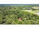 Expansive aerial view of a secluded residence surrounded by lush, mature trees providing privacy at 2156 Wedgewood Dr, Matthews, NC 28104