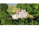 Aerial perspective of home with well-maintained lawn, mature trees, a circular driveway, and back patio at 2156 Wedgewood Dr, Matthews, NC 28104
