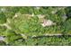 Expansive aerial view of lush property with mature trees, a winding driveway, and a well-maintained home at 2156 Wedgewood Dr, Matthews, NC 28104