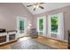 Cozy bedroom with light-colored walls, hard wood floors, vaulted ceiling and a large window overlooking the backyard at 2156 Wedgewood Dr, Matthews, NC 28104