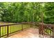 Wooden deck overlooking a well-manicured backyard with plenty of surrounding mature trees at 2156 Wedgewood Dr, Matthews, NC 28104