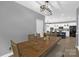 A dining area with a large wooden table, bench seating, and view into the kitchen at 2156 Wedgewood Dr, Matthews, NC 28104