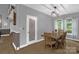 Dining area with wooden table and chairs, view of a pantry, and natural light from the windows at 2156 Wedgewood Dr, Matthews, NC 28104