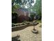 Landscaped front yard with stone pathway, brick accents, mature shrubs, and an American flag at 2156 Wedgewood Dr, Matthews, NC 28104