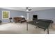 Open game room with comfortable seating, a flat screen tv, and ping pong table for entertainment at 2156 Wedgewood Dr, Matthews, NC 28104
