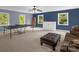 Spacious game room featuring a ping pong table, seating, and natural light from the surrounding windows at 2156 Wedgewood Dr, Matthews, NC 28104