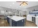 Bright, open kitchen with a large island, seating, stainless steel appliances, and views of the living area at 2156 Wedgewood Dr, Matthews, NC 28104