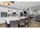 Stylish kitchen with island seating, stainless appliances, white cabinets, and open view to the living room at 2156 Wedgewood Dr, Matthews, NC 28104