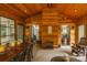 Beautiful sunroom boasts a wood ceiling, cozy fireplace, and elegant dining area with natural light at 2156 Wedgewood Dr, Matthews, NC 28104