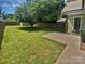 Spacious backyard with mature tree, green grass, storage shed and privacy fence at 2222 Camp Greene St, Charlotte, NC 28208