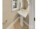 Chic half-bath with pedestal sink and patterned flooring at 2222 Camp Greene St, Charlotte, NC 28208