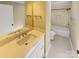 Bathroom featuring vanity with sink, mirror, and tub-shower combo with tiled walls at 2222 Camp Greene St, Charlotte, NC 28208