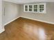 Bright bedroom with gleaming hardwood floors, fresh paint, and natural light from the three-part window at 2222 Camp Greene St, Charlotte, NC 28208