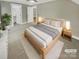 Comfortable main bedroom with neutral tones, soft carpet, and walk-in closet at 2222 Camp Greene St, Charlotte, NC 28208