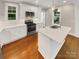 Modern kitchen featuring white cabinets, stainless steel appliances, and a center island at 2222 Camp Greene St, Charlotte, NC 28208