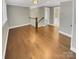 Open living area with hardwood floors, neutral walls, and access to staircase and second floor at 2222 Camp Greene St, Charlotte, NC 28208