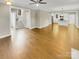 Bright, open-concept living room featuring hardwood floors and a ceiling fan at 2222 Camp Greene St, Charlotte, NC 28208