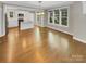 Sunlit living room and kitchen featuring hardwood floors and recessed lighting at 2222 Camp Greene St, Charlotte, NC 28208