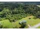 Expansive wooded property featuring a single-story home with green roof and several storage sheds at 223 Green Meadows Dr, Kings Mountain, NC 28086