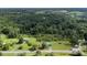 Aerial view of wooded property and homes with metal roofs and large yards at 223 Green Meadows Dr, Kings Mountain, NC 28086