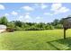 Spacious backyard with lush green grass and mature trees at 223 Green Meadows Dr, Kings Mountain, NC 28086