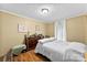 Bedroom features a dresser with decorative lamps, a small stool, and wood floors at 223 Green Meadows Dr, Kings Mountain, NC 28086