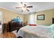 Comfortable bedroom with ceiling fan, dark wood dresser, and a mounted television at 223 Green Meadows Dr, Kings Mountain, NC 28086