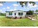 Charming single story home featuring a landscaped yard, front porch, and wheelchair ramp access at 223 Green Meadows Dr, Kings Mountain, NC 28086