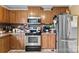 Modern kitchen features a stainless steel refrigerator, ample counter space and wooden cabinetry at 223 Green Meadows Dr, Kings Mountain, NC 28086