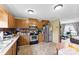 Well-lit kitchen with stainless steel appliances, plenty of cabinet space, and hardwood floors at 223 Green Meadows Dr, Kings Mountain, NC 28086