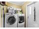 Bright laundry room with front loading washer and dryer and storage shelving at 223 Green Meadows Dr, Kings Mountain, NC 28086