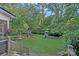 Large backyard boasts a playset with slide and climbing areas, and a storage shed surrounded by mature trees at 2358 Sparrow Dr, Rock Hill, SC 29732