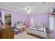 Bright bedroom features a ceiling fan, white trim, and plenty of space for a desk and storage at 2358 Sparrow Dr, Rock Hill, SC 29732