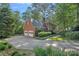 Brick home with a two-car garage, mature trees, and lush landscaping at 2358 Sparrow Dr, Rock Hill, SC 29732