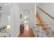 Bright hallway with hardwood floors, staircase, and view into the kitchen at 2358 Sparrow Dr, Rock Hill, SC 29732