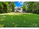 Spacious backyard featuring lush green grass, mature trees, and well-maintained landscaping at 2455 Talbot Ct, Sherrills Ford, NC 28673
