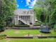 Expansive backyard with a well-manicured lawn, mature trees, and tiered landscaping with a trampoline at 2455 Talbot Ct, Sherrills Ford, NC 28673
