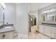 Well-lit bathroom featuring double sinks with grey countertops and tiled floors at 2455 Talbot Ct, Sherrills Ford, NC 28673
