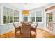 Charming dining area with hardwood floors, surrounded by natural light from the surrounding windows at 2455 Talbot Ct, Sherrills Ford, NC 28673
