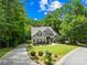 Beautifully landscaped home with lush greenery, a circular driveway, and classic architectural details at 2455 Talbot Ct, Sherrills Ford, NC 28673