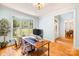 Well-lit home office featuring hardwood floors, a large window overlooking the front yard, and a comfortable workspace at 2455 Talbot Ct, Sherrills Ford, NC 28673