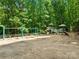 Community playground featuring swings, slides, climbing structures, and picnic tables nestled within a wooded area at 2455 Talbot Ct, Sherrills Ford, NC 28673