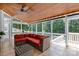 Inviting screened porch featuring comfortable seating, wood ceiling, and views of the private backyard at 2455 Talbot Ct, Sherrills Ford, NC 28673