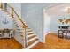 Inviting foyer with wooden staircase, white railing, and access to hardwood floors at 2455 Talbot Ct, Sherrills Ford, NC 28673
